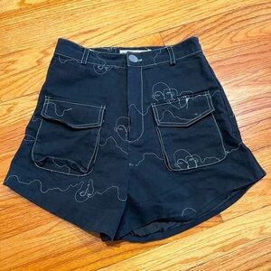 Black dressy cargo pocket shorts with unique thread faces detailing- avant garde